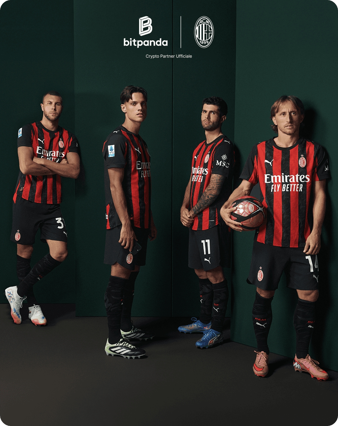 Four soccer players in red and black striped jerseys pose with a ball against a dark green background, featuring Bitpanda and AC Milan logos.