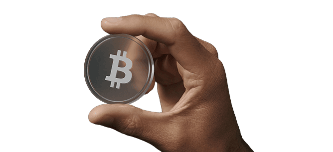 Hand holding a transparent round token with a white Bitcoin symbol on it against a dark background.