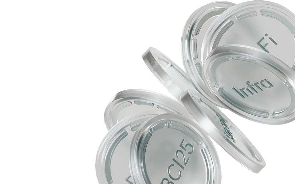 Transparent petri dishes labeled "Fi," "Infra," and "BCI25," stacked and slightly tilted against a white background.